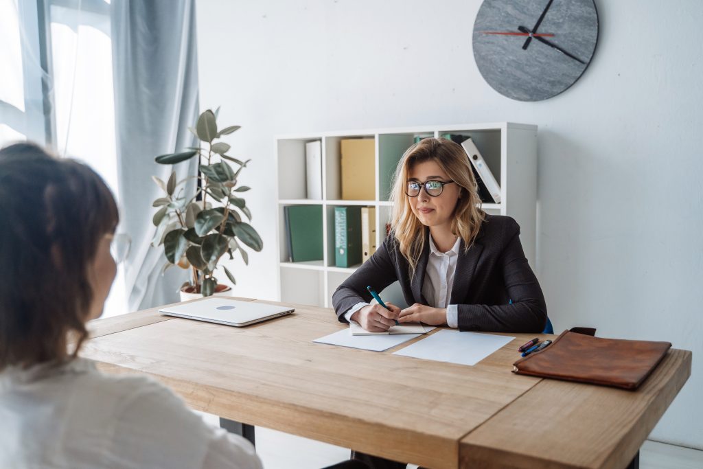 Young female candidate interviewed by employer HR interview tips for freshers